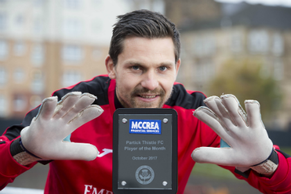 web Tomas with unbranded gloves and trophy.png